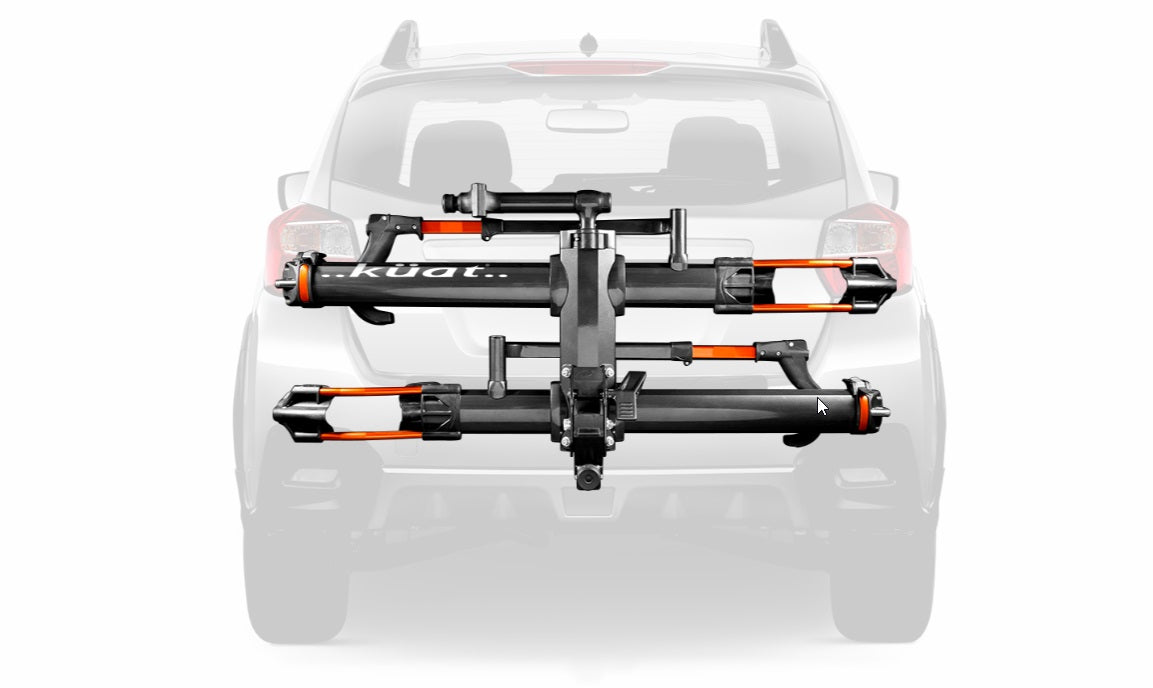 Adjustable front tire cradle system. Pivot with optional foot assist. Trail Doc included. Fully integrated cable locks and hitch lock included. Front tire ratchet with intuitive release. Rear tire strap features co-molded strap to protect wheels. No-tool install with hand tight hitch cam system. Premium gloss metallic powder with water transferred logos. Available in both 2” & 1.25” hitch sizes. NOT RV compatible. #Kuat_NV-2-0_Bike_Hitch_Rack_Orange